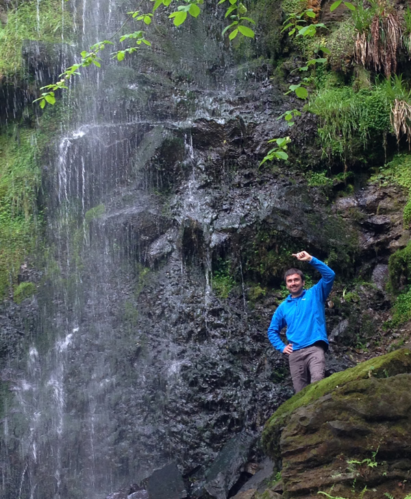 Man stood with a waterfall